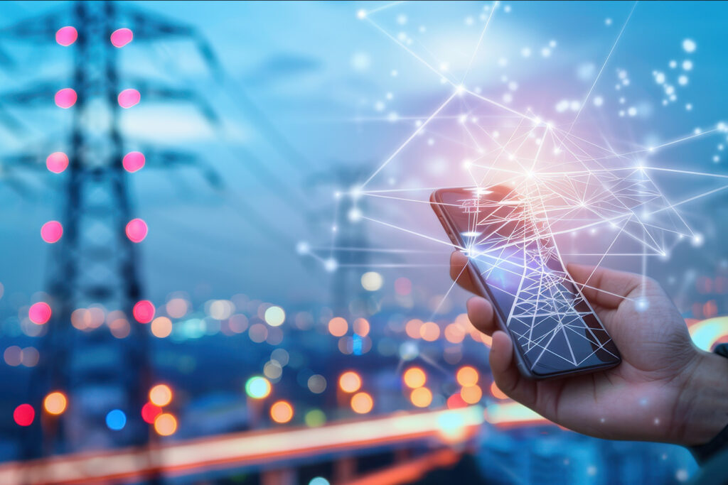 Hand holding a smartphone emitting connected digital signal lines, with a cellular tower in the background, illustrating wireless technology, electromagnetic fields (EMF), and modern connectivity.